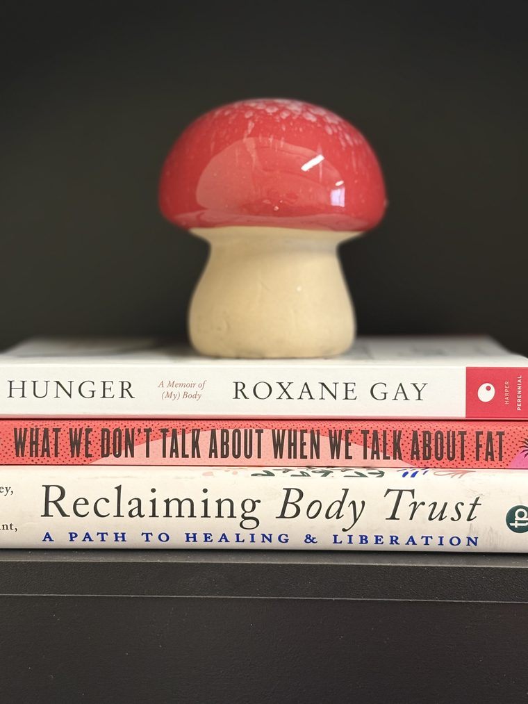 Books in the consulting room, including Hunger by Roxane Gay and Reclaiming Body Trust
