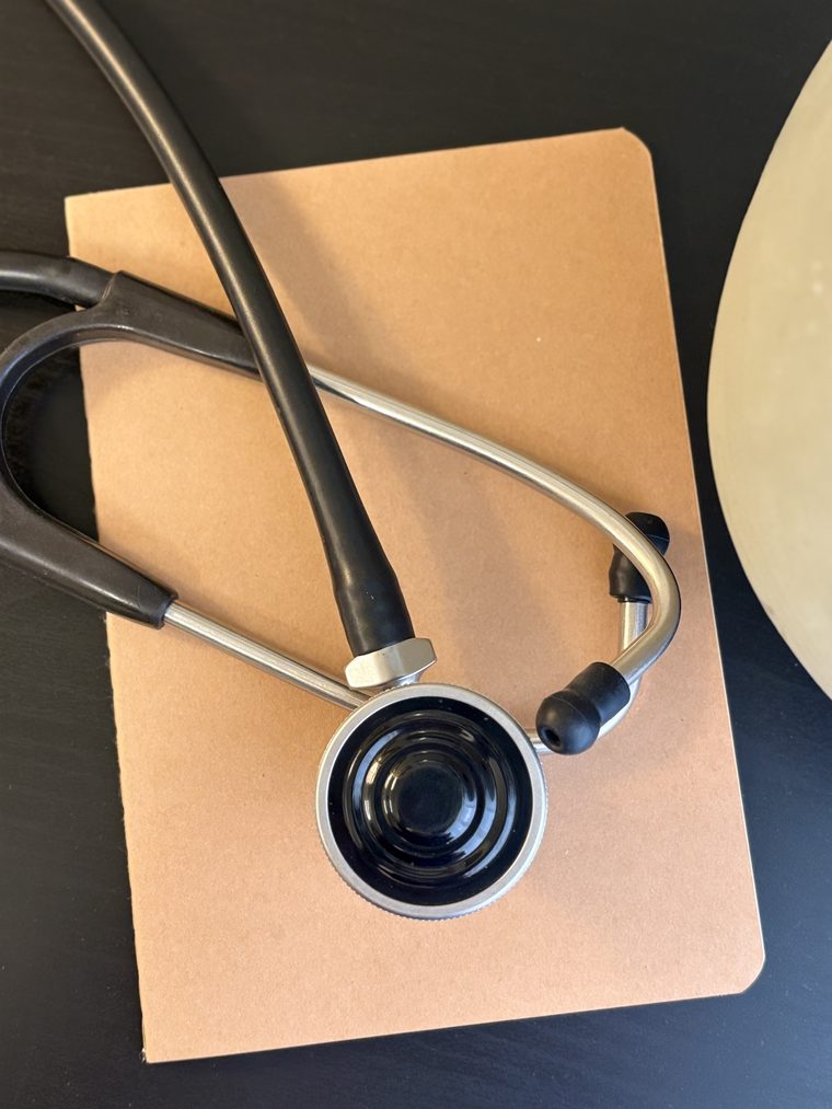 A stethoscope resting on a paper folder