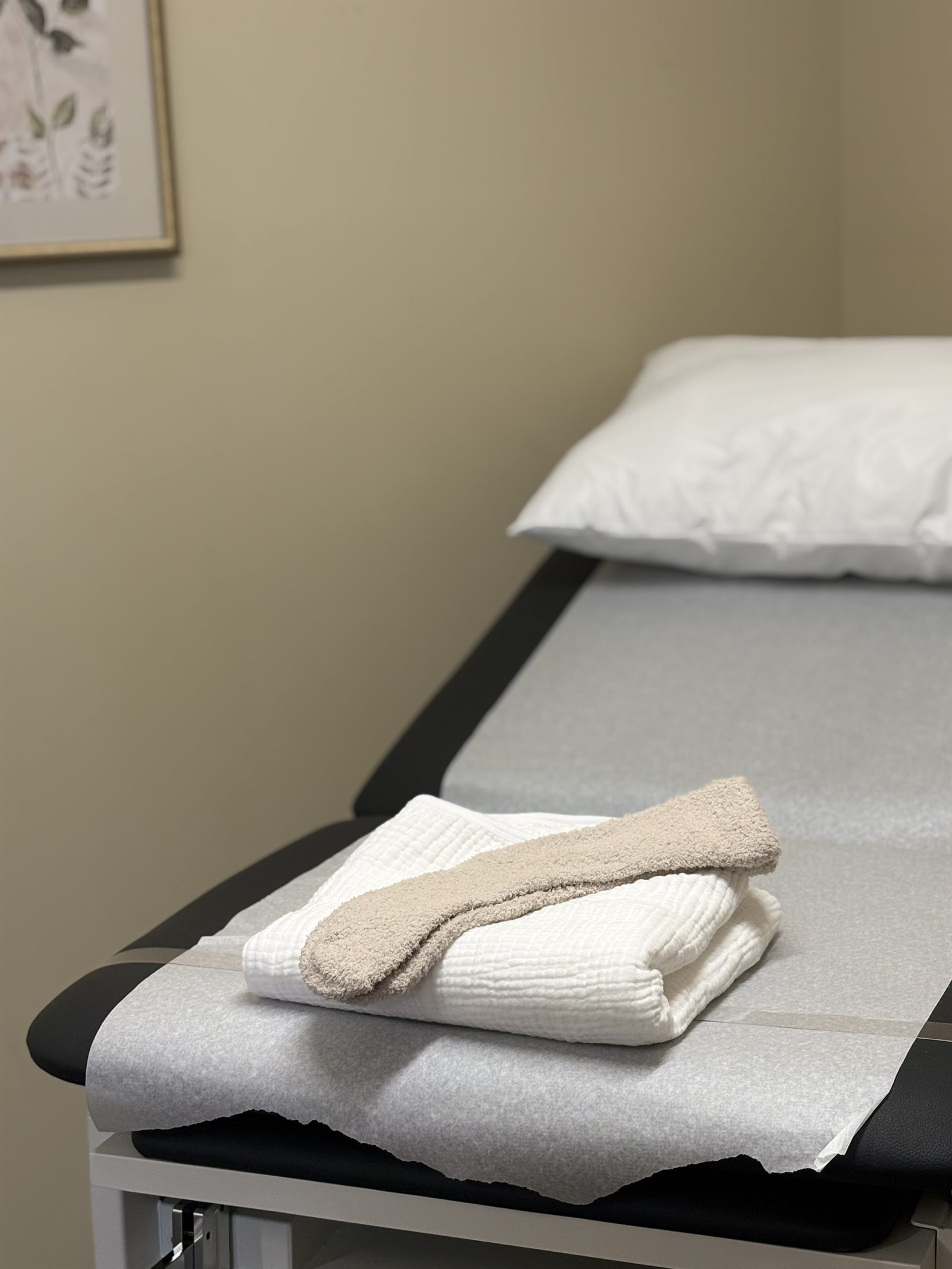 An exam table with folded blankets in the Sorrel office