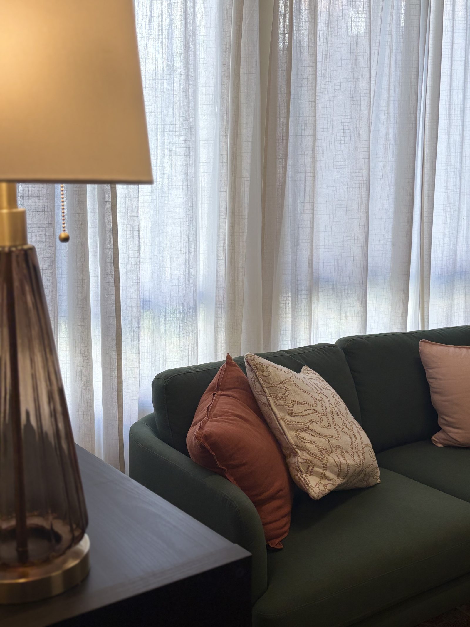 A lamp and framed botanical prints on a wall in the Sorrel office