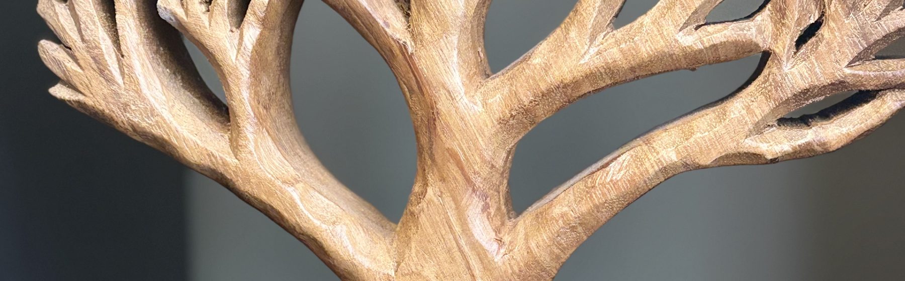 A carved wooden tree on a shelf in the Sorrel office